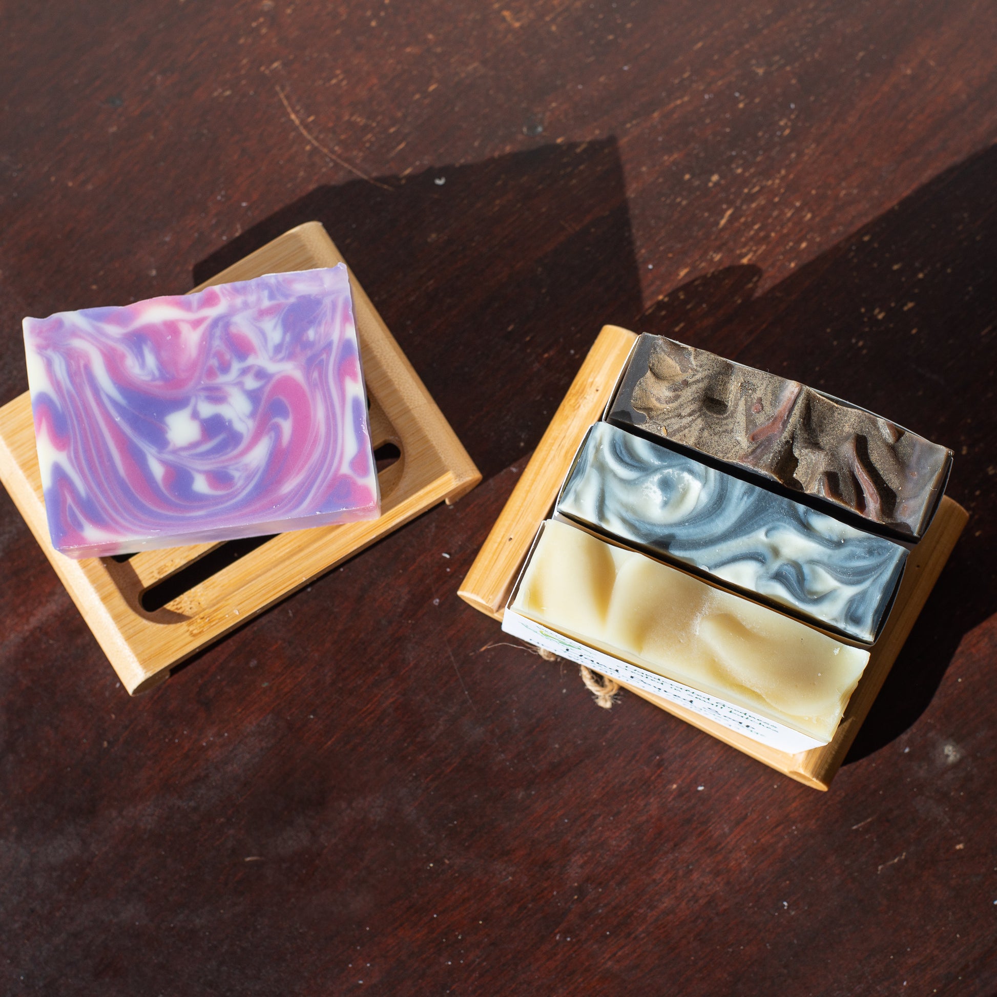 4 bars of soap sitting on 2 ecofriendly soap lifts