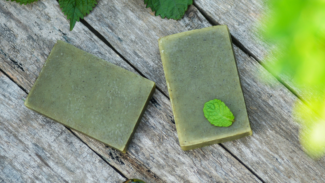 Image of 2 handmade bars of soap on a wood background