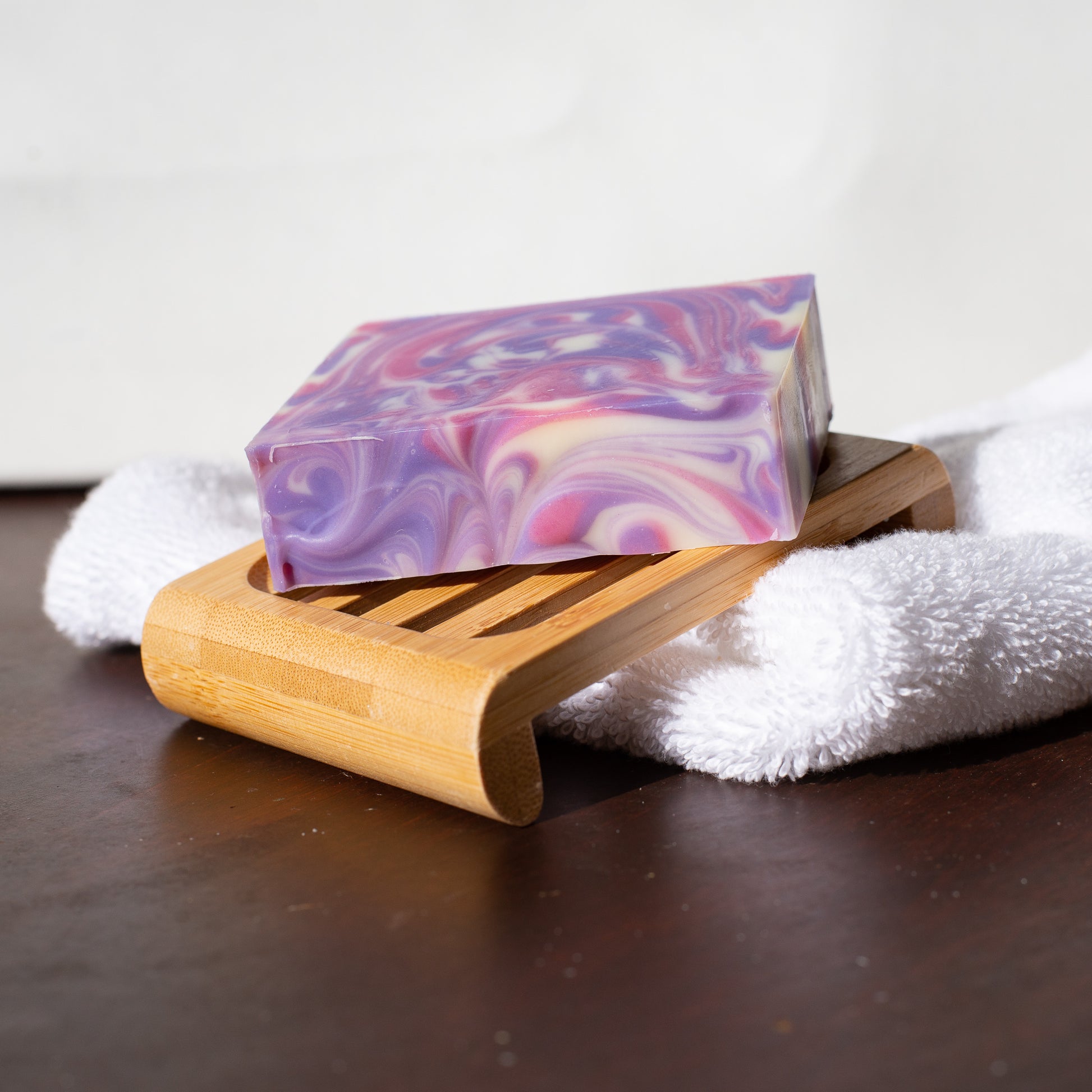 A bar of soap on a soap dish with a washcloth